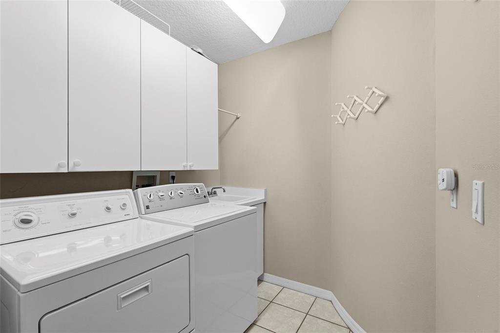 7822 Troon Court Lakewood Ranch, FL 34202 - Photo 42 of 83 a view of storage and utility room with washer and dryer