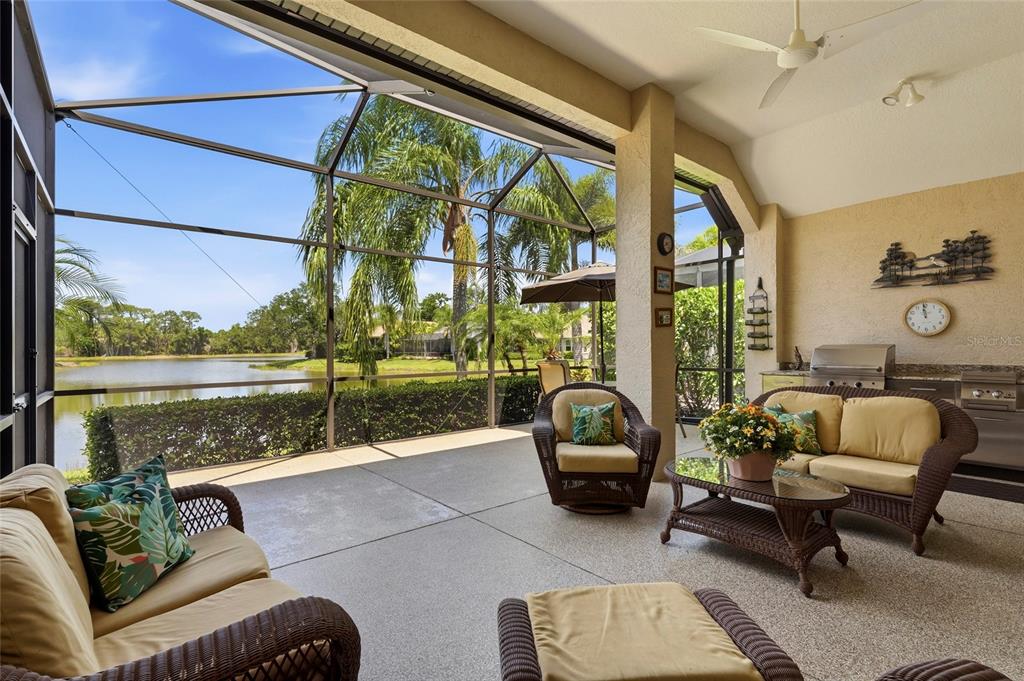 7822 Troon Court Lakewood Ranch, FL 34202 - Photo 44 of 83 a living room with patio furniture and a floor to ceiling window