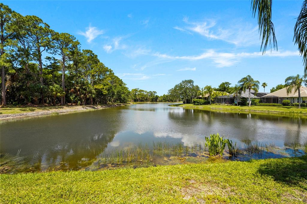 7822 Troon Court Lakewood Ranch, FL 34202 - Photo 51 of 83 a view of a lake with houses in the back