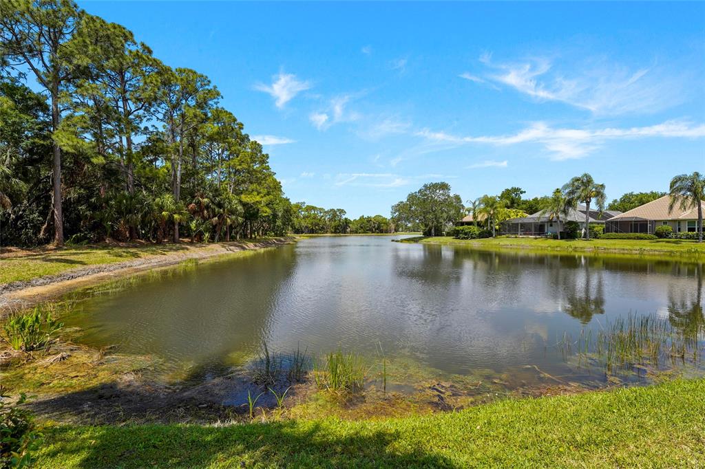7822 Troon Court Lakewood Ranch, FL 34202 - Photo 52 of 83 a view of a lake with houses in the back