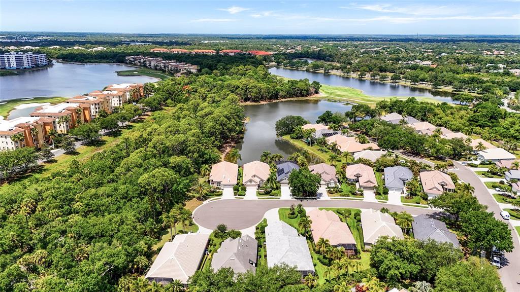 7822 Troon Court Lakewood Ranch, FL 34202 - Photo 56 of 83 an aerial view of residential houses with outdoor space and lake view