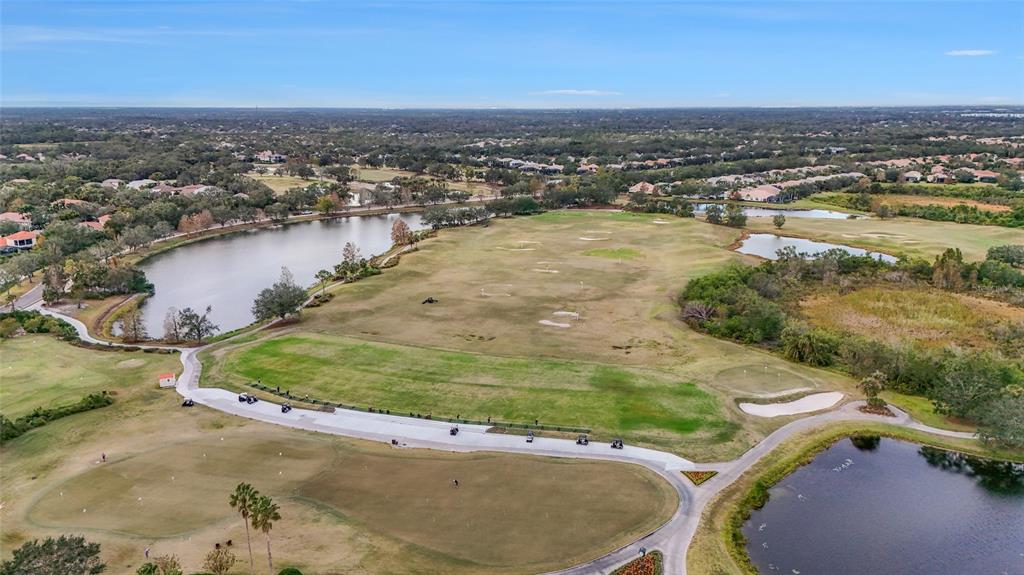 7822 Troon Court Lakewood Ranch, FL 34202 - Photo 76 of 83 an aerial view of a residential houses with outdoor space and trees
