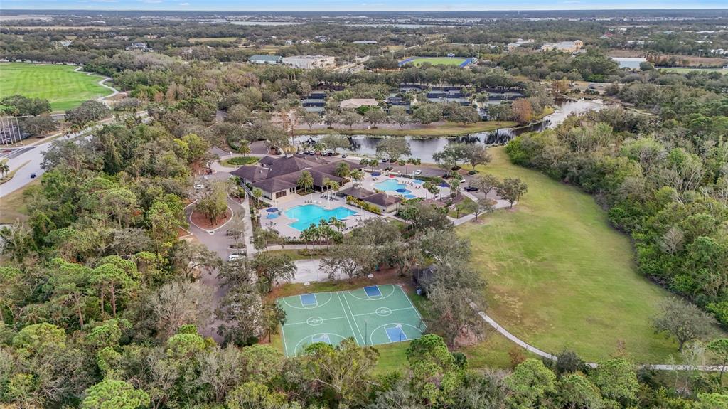7822 Troon Court Lakewood Ranch, FL 34202 - Photo 81 of 83 an aerial view of residential houses with outdoor space and trees