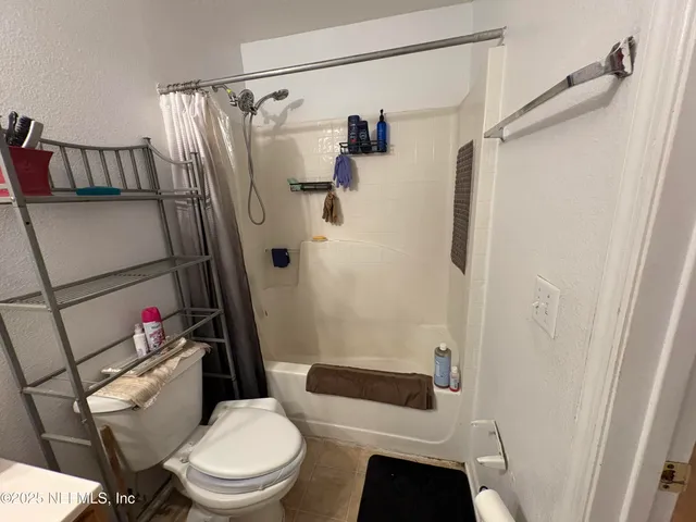 a white toilet sitting next to a bathroom sink and shower