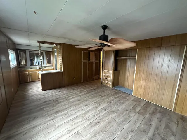 a view of a refrigerator in kitchen and wooden floor