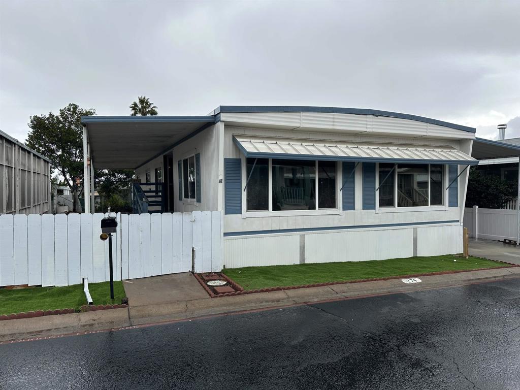 8301 Mission Gorge Road, Unit 274 Santee, CA 92071 - Photo 2 of 41 a front view of a house with a garden