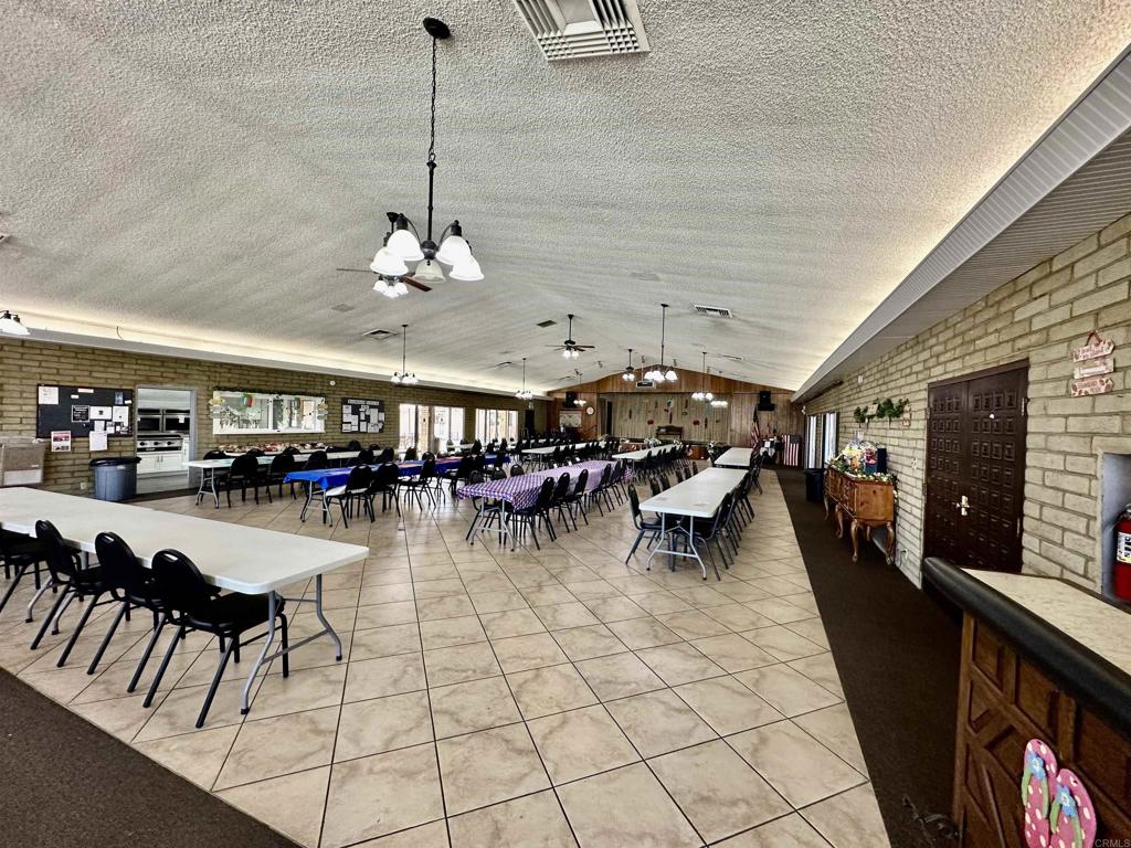 8301 Mission Gorge Road, Unit 274 Santee, CA 92071 - Photo 30 of 41 a living room with lots of furniture and a chandelier