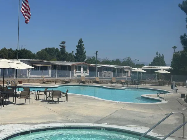 a view of a swimming pool and lounge chairs
