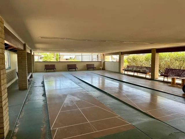 a living room with furniture a dining table and a fireplace