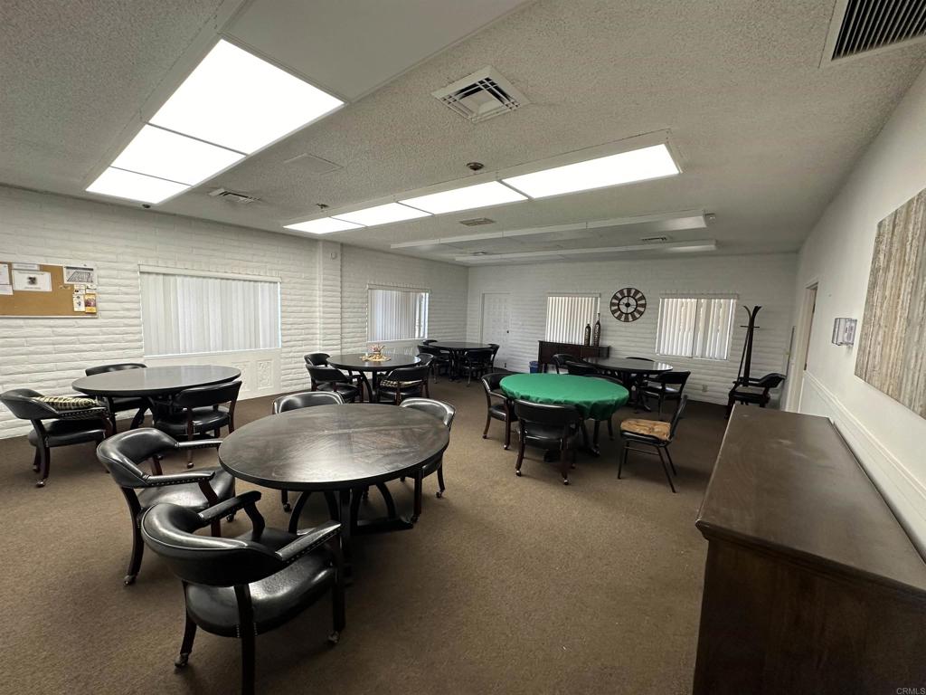 8301 Mission Gorge Road, Unit 274 Santee, CA 92071 - Photo 41 of 41 a living room with furniture a dining table and a fireplace