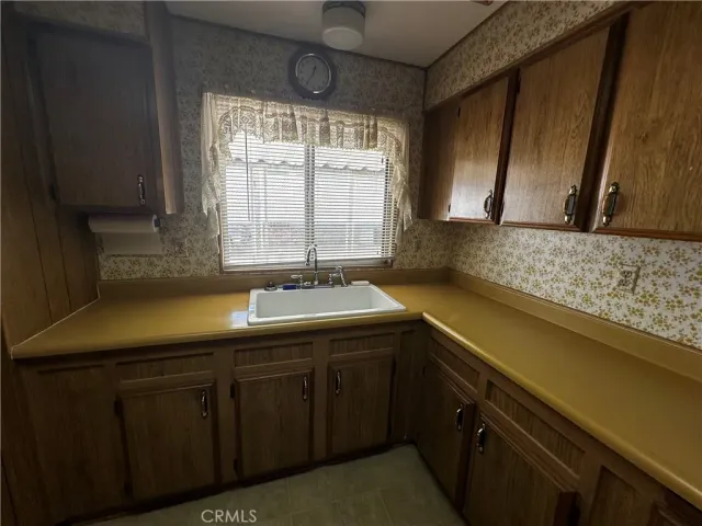 a kitchen with a sink and cabinets