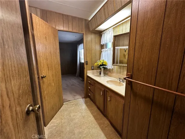 a bathroom with a double vanity sink and mirror