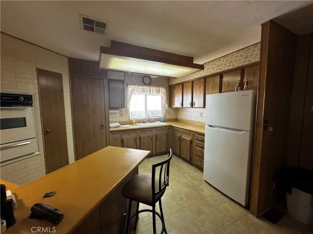 a kitchen with a refrigerator a sink and dishwasher