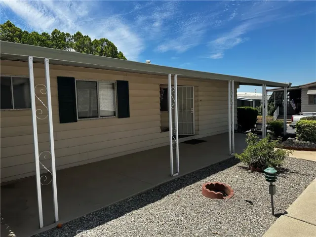 a backyard of a house with yard and outdoor seating