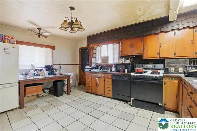 a room with a refrigerator and a stove
