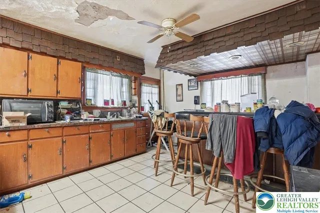 a view of a livingroom with workspace and a window