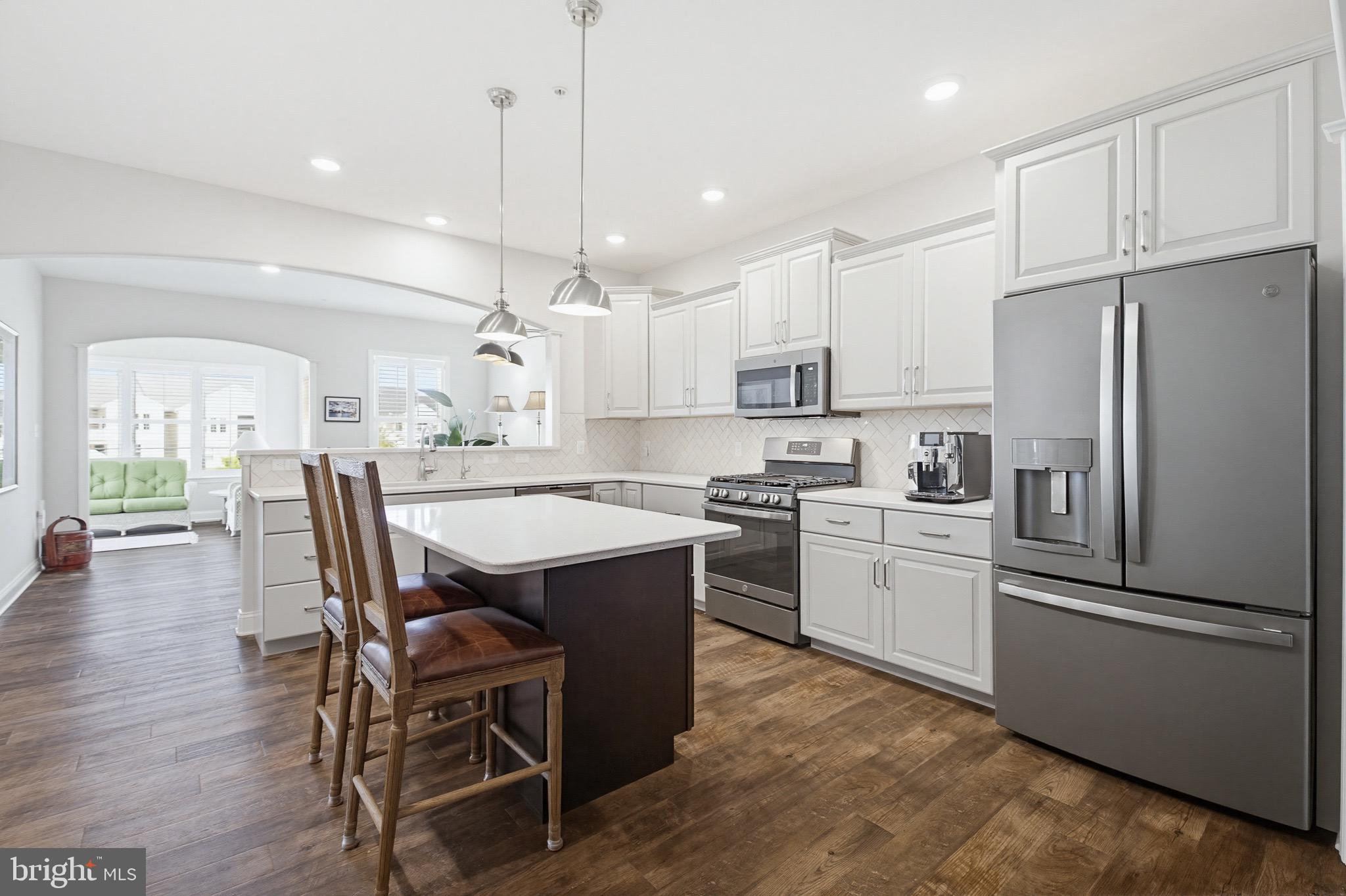 361 Meadow Rose Drive Lititz, PA 17543 - Photo 9 of 39 a kitchen with stainless steel appliances granite countertop a refrigerator a stove a sink a dining table and chairs with wooden floor