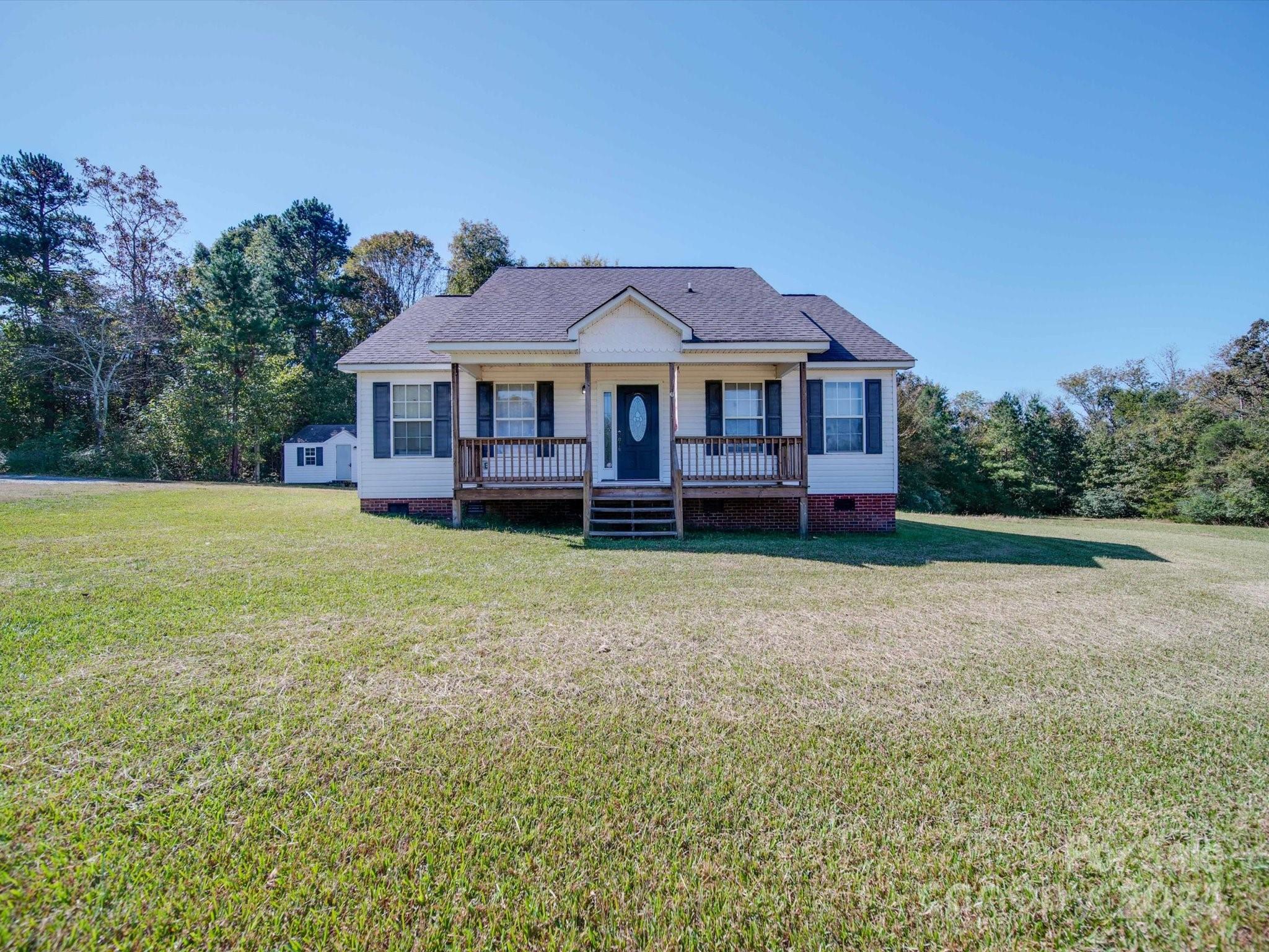 6312 Plyler Mill Road Monroe, NC 28112 - Photo 1 of 41 a view of a house with a yard and large trees