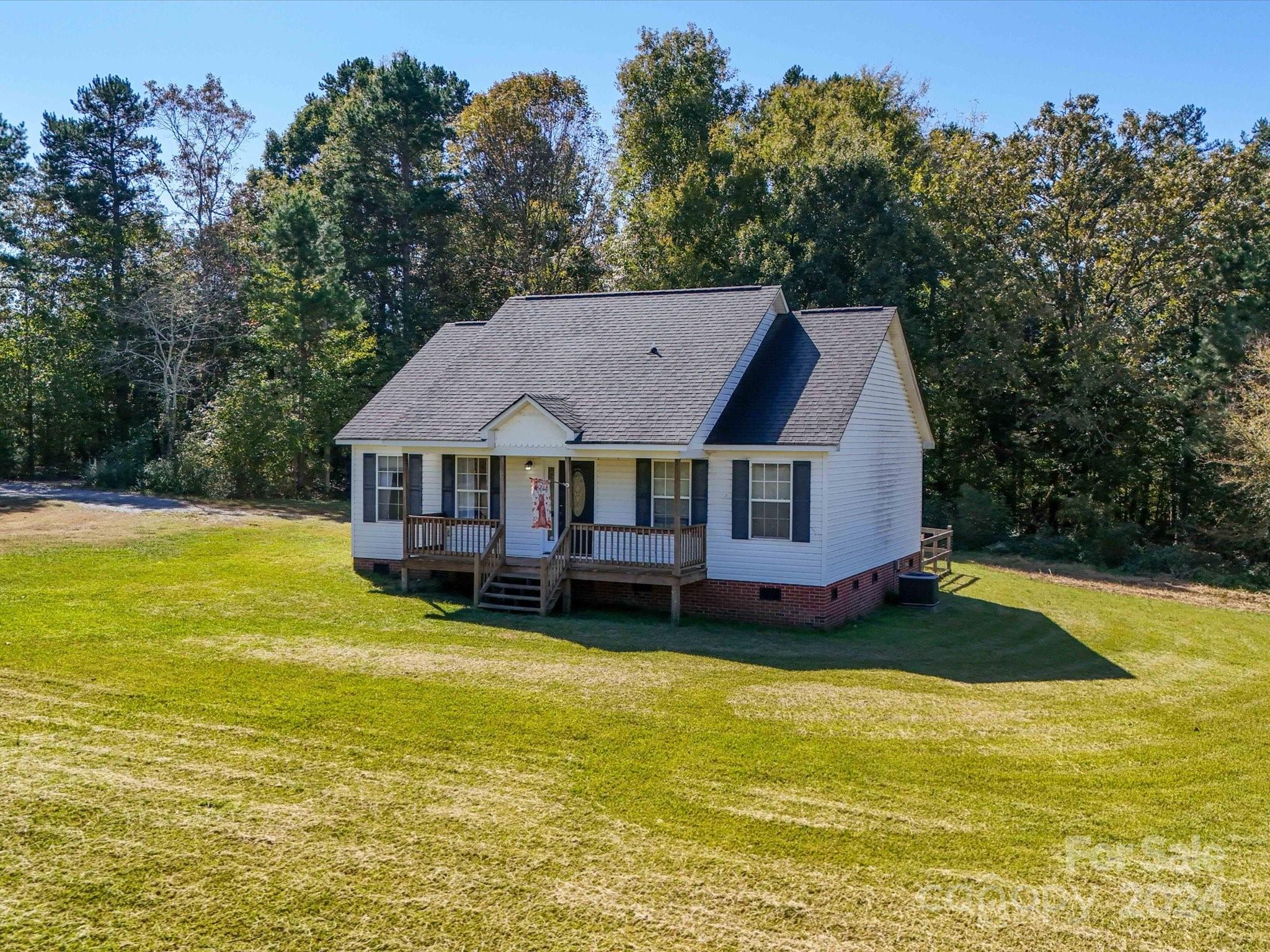 6312 Plyler Mill Road Monroe, NC 28112 - Photo 2 of 41 a aerial view of a house with swimming pool and large trees