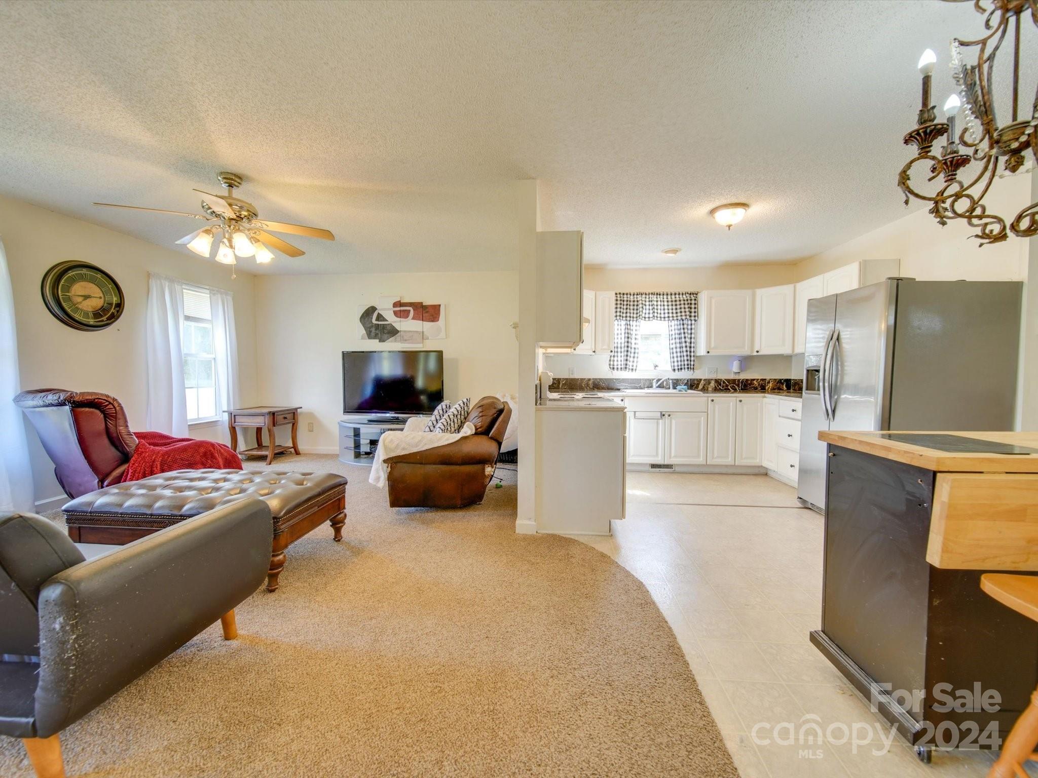 6312 Plyler Mill Road Monroe, NC 28112 - Photo 23 of 41 a living room with furniture and a clock