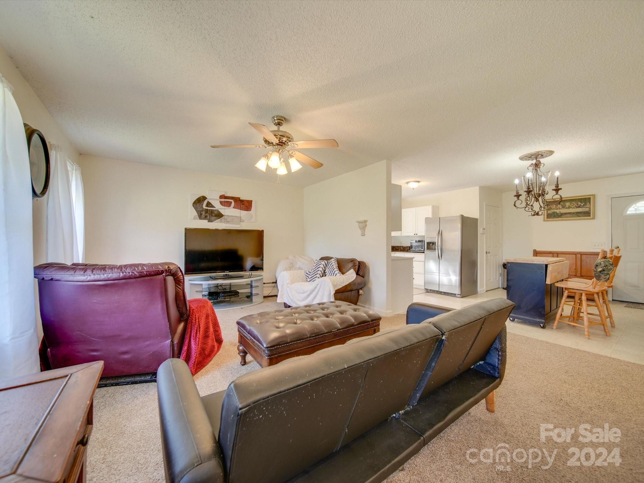 6312 Plyler Mill Road Monroe, NC 28112 - Photo 24 of 41 a living room with furniture and a flat screen tv