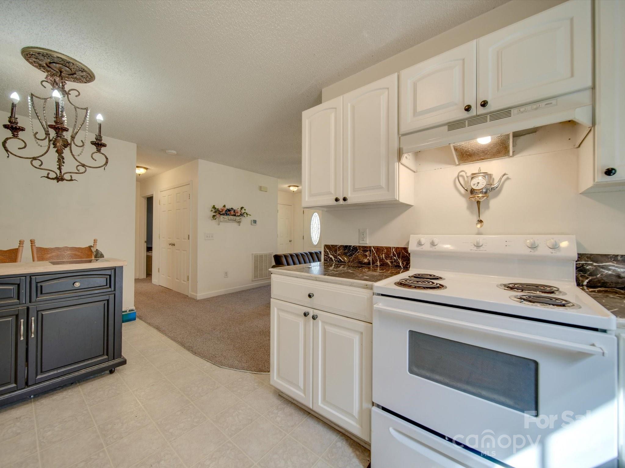 6312 Plyler Mill Road Monroe, NC 28112 - Photo 28 of 41 a kitchen with cabinets appliances and wooden floor