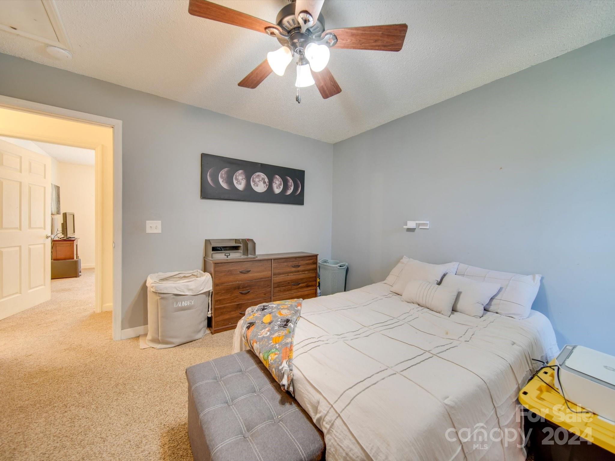 6312 Plyler Mill Road Monroe, NC 28112 - Photo 34 of 41 a bedroom with a bed and a chandelier