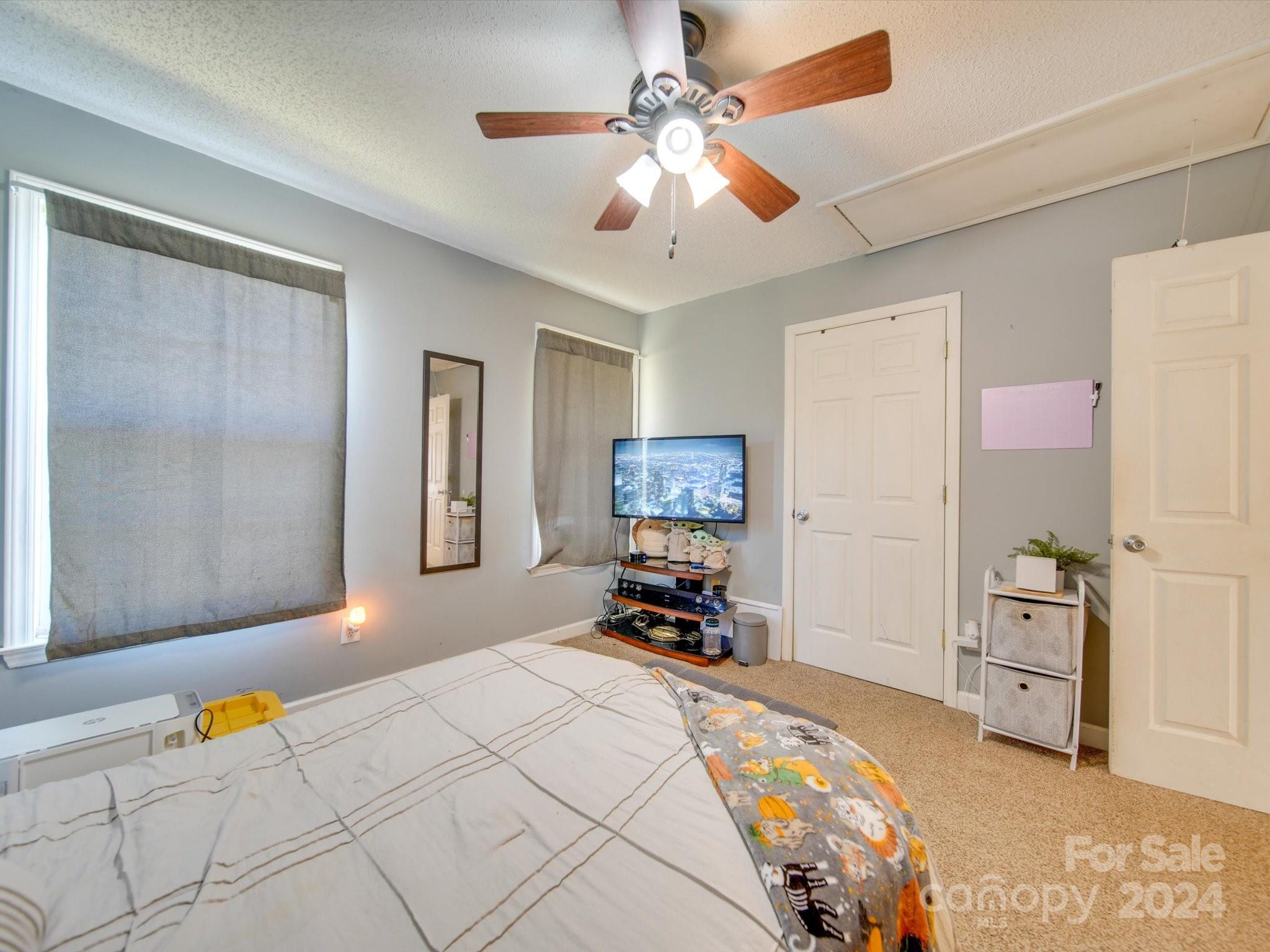 6312 Plyler Mill Road Monroe, NC 28112 - Photo 35 of 41 a bedroom with a bed dresser and a window