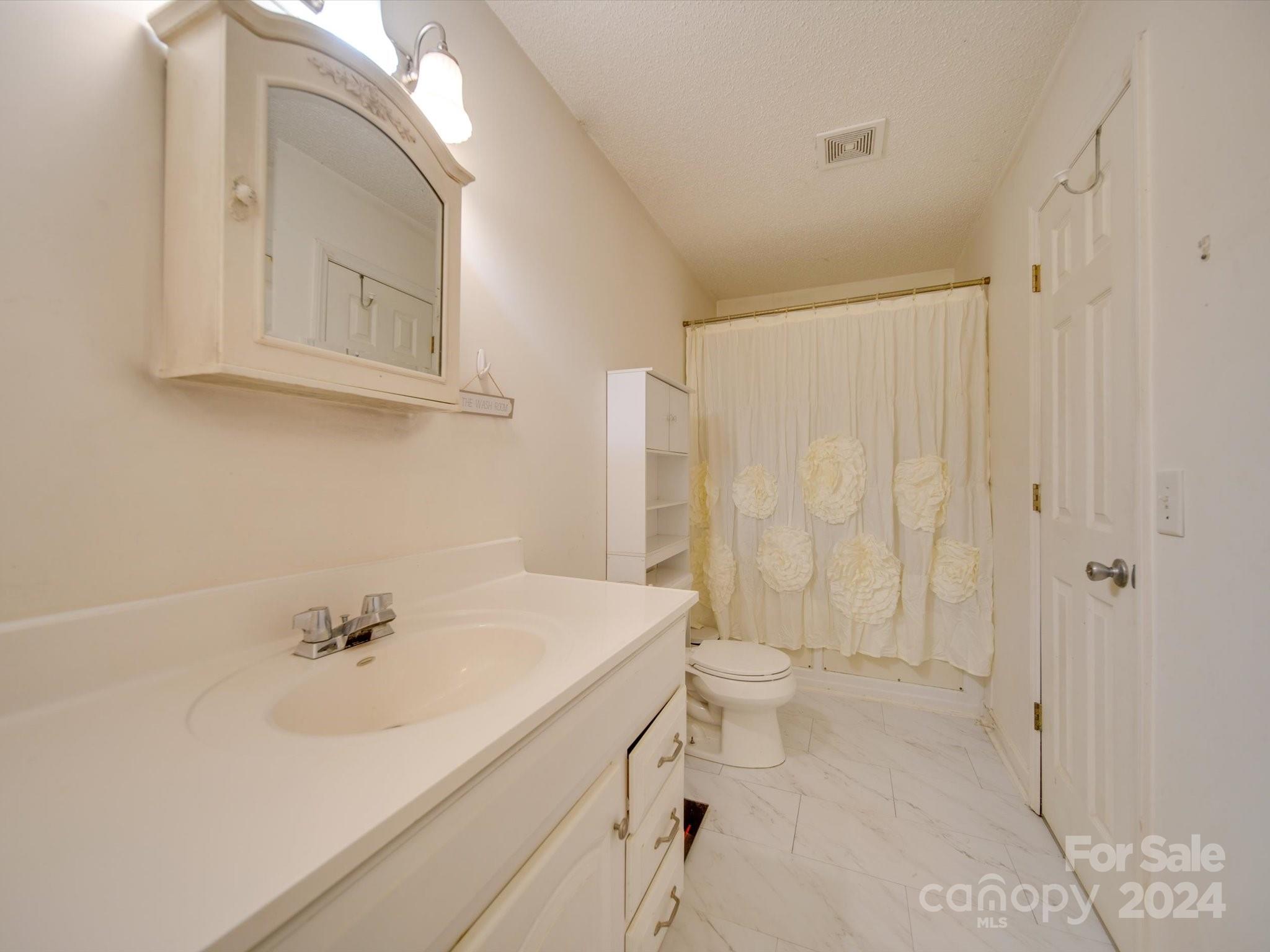 6312 Plyler Mill Road Monroe, NC 28112 - Photo 41 of 41 a bathroom with a sink a toilet and shower