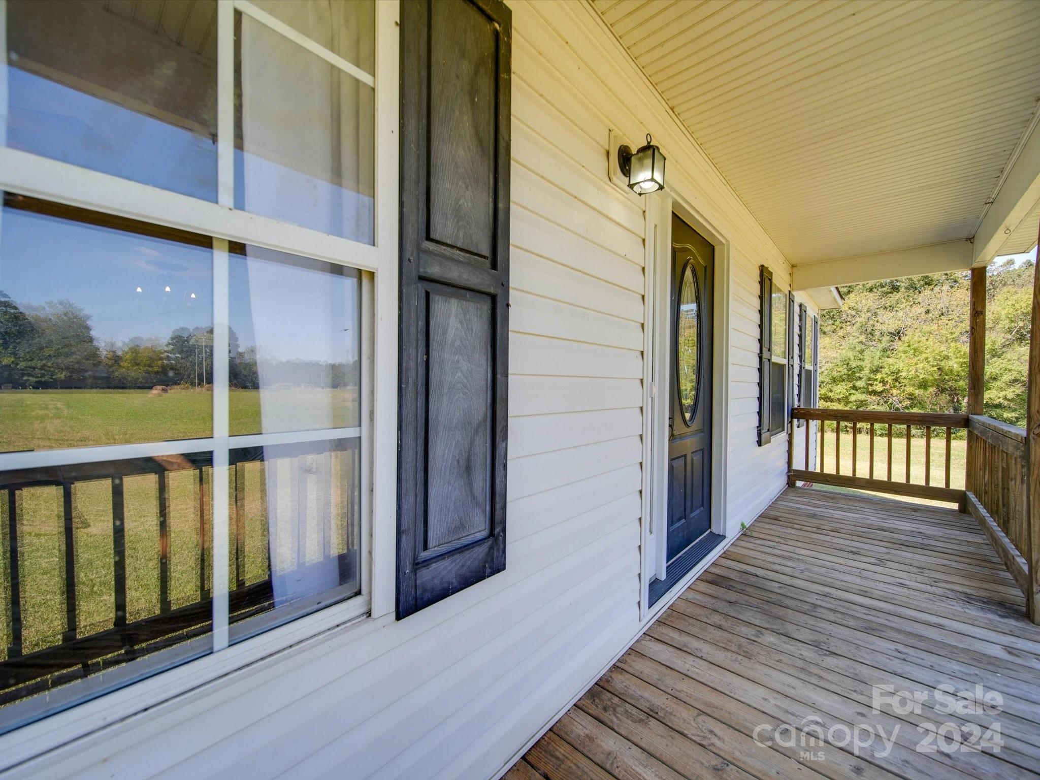 6312 Plyler Mill Road Monroe, NC 28112 - Photo 6 of 41 a view of a balcony with wooden floor