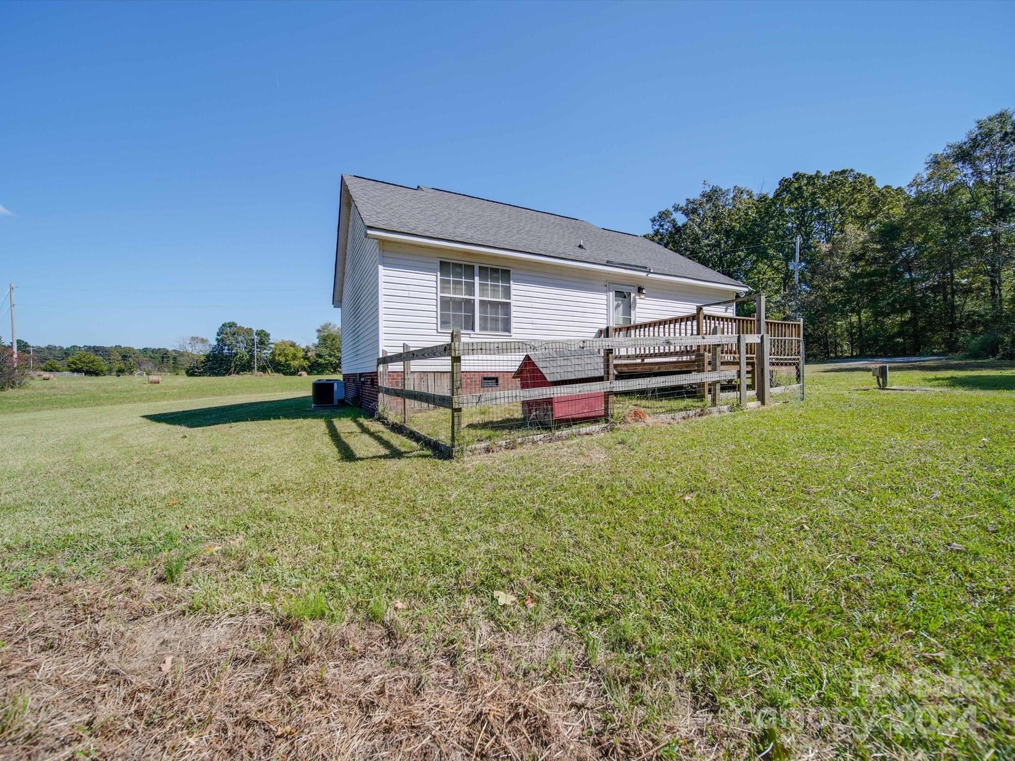 6312 Plyler Mill Road Monroe, NC 28112 - Photo 8 of 41 a backyard of a house with a yard and outdoor seating