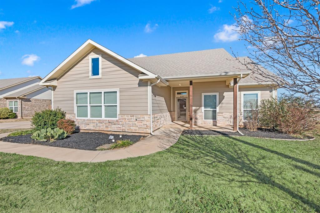 a front view of a house with a yard