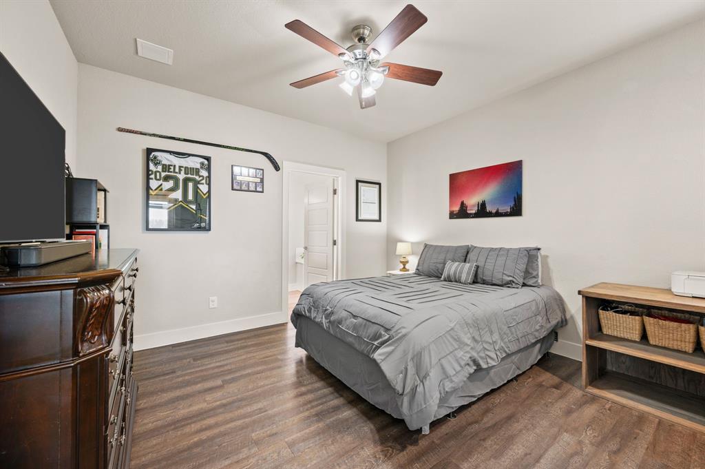 824 East Northside Drive Pilot Point, TX 76258 - Photo 12 of 23 a bedroom with a bed and a flat screen tv