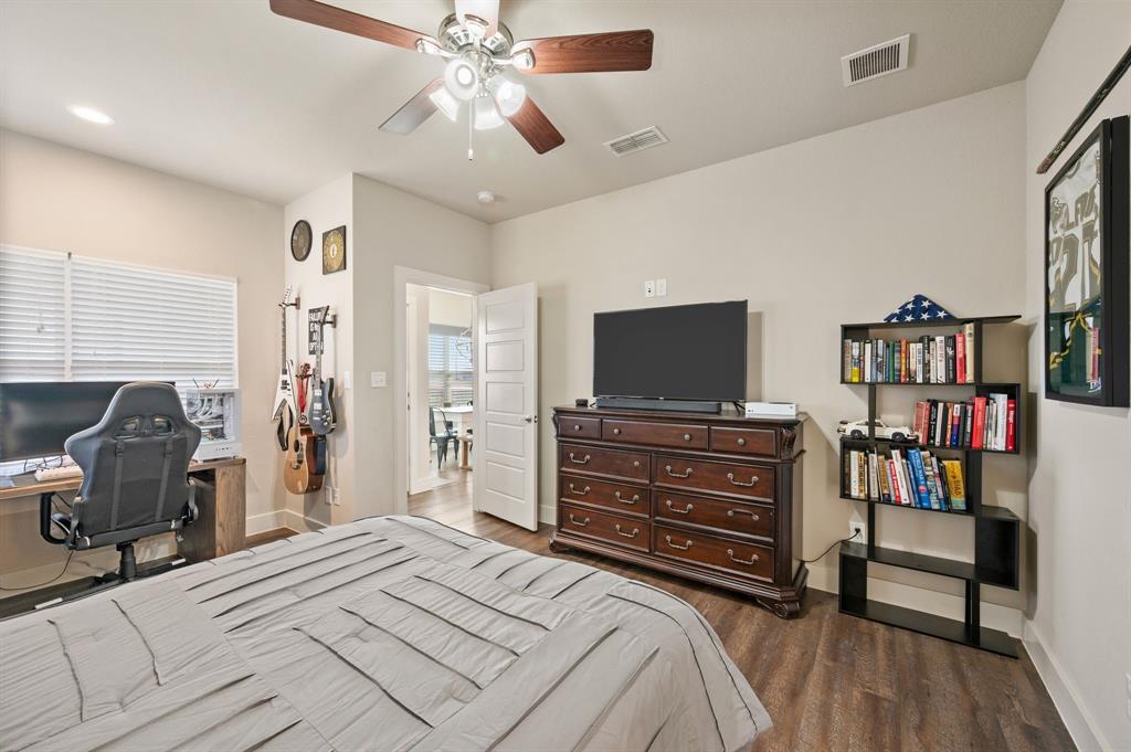 824 East Northside Drive Pilot Point, TX 76258 - Photo 13 of 23 a bedroom with a bed and a flat screen tv
