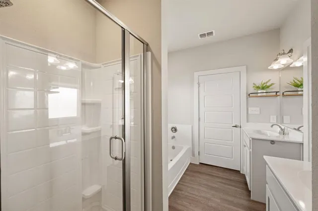 a bathroom with a double vanity sink toilet and shower