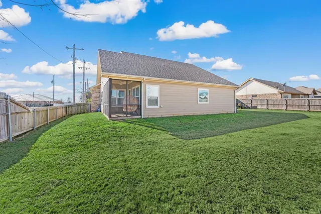 a view of a house with a yard and porch