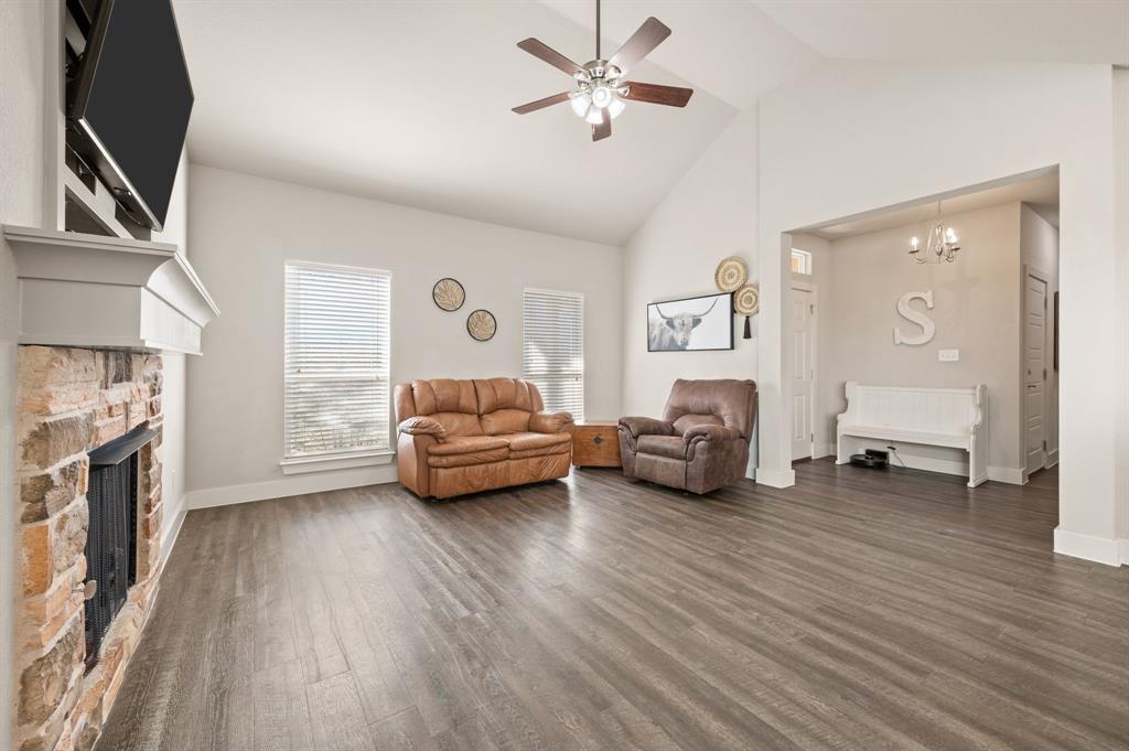 824 East Northside Drive Pilot Point, TX 76258 - Photo 5 of 23 a bedroom with furniture and a fireplace
