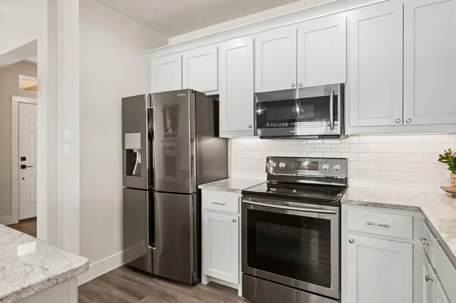 a kitchen with a stove microwave and refrigerator