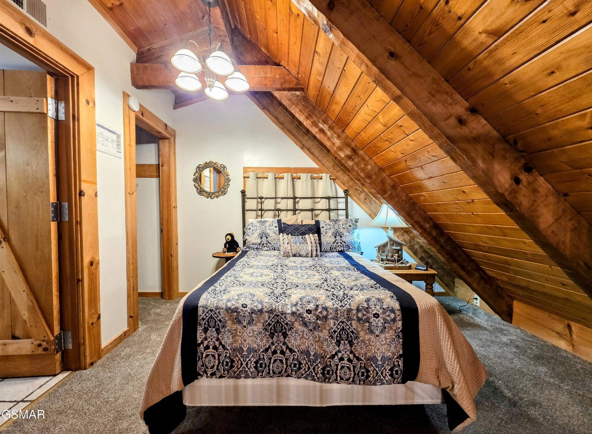 2570 Pittman Center Road Sevierville, TN 37876 - Photo 26 of 61 a bed sitting in a bedroom next to a window