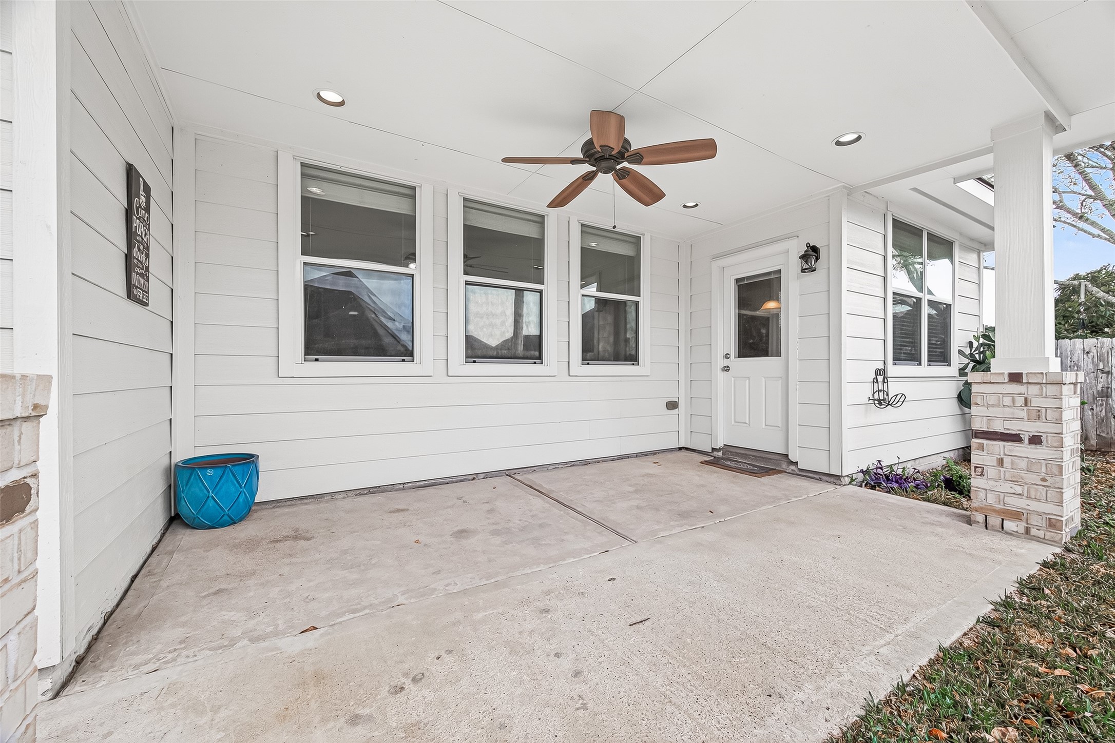 9110 Cavalier Lane Rosenberg, TX 77469 - Photo 28 of 30 This is a welcoming covered patio area with clean white siding and a ceiling fan. It features ample space, recessed lighting. Ideal for relaxation or entertaining.