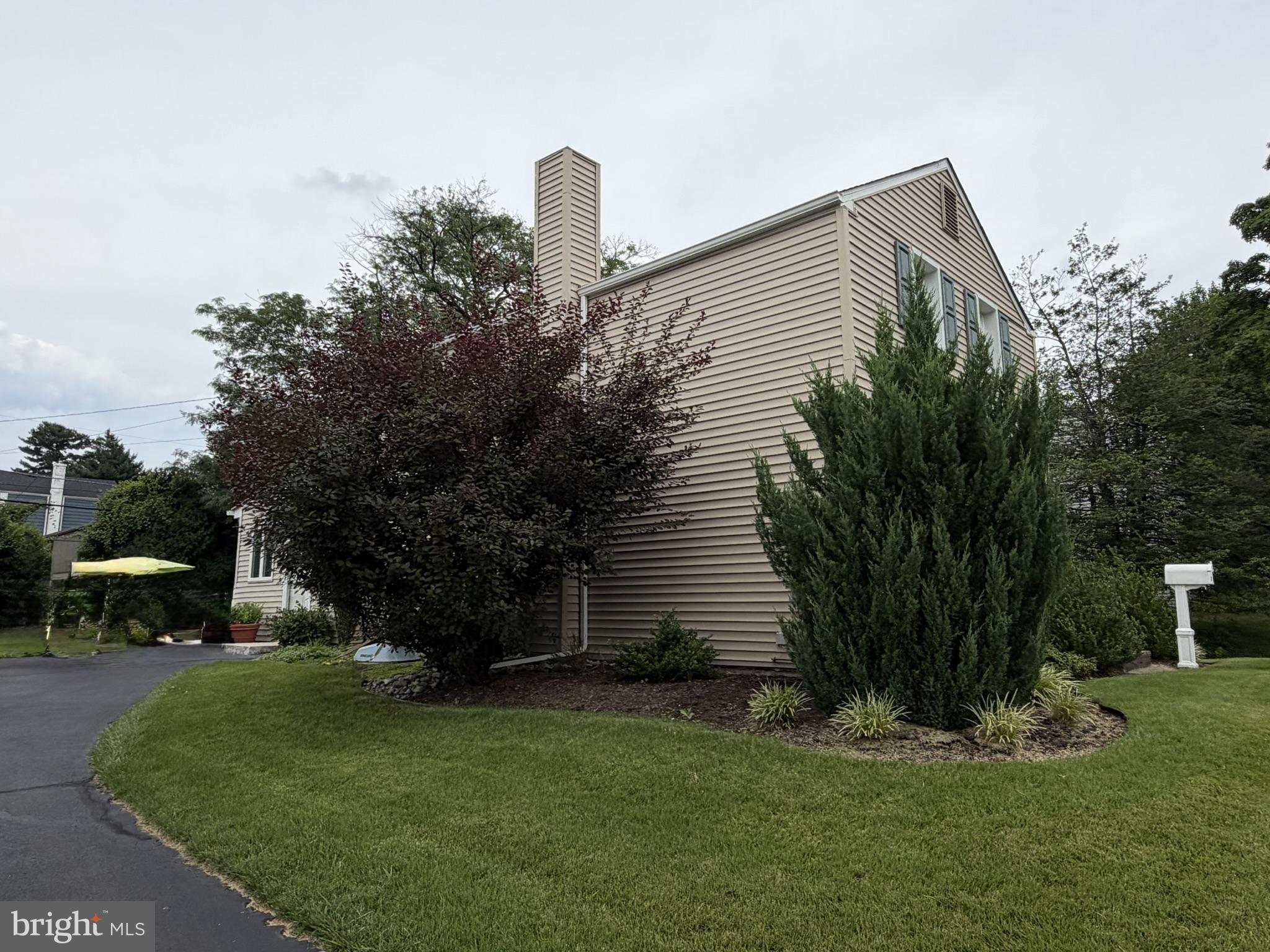 217 Lyster Road Oreland, PA 19075 - Photo 5 of 11 Charming home with lush greenery.