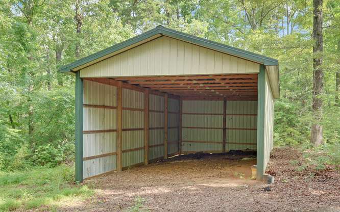 330 River Road Westminster, SC 29693 - Photo 37 of 45 A spacious barn provides versatile shelter for equipment or livestock amidst a verdant landscape.