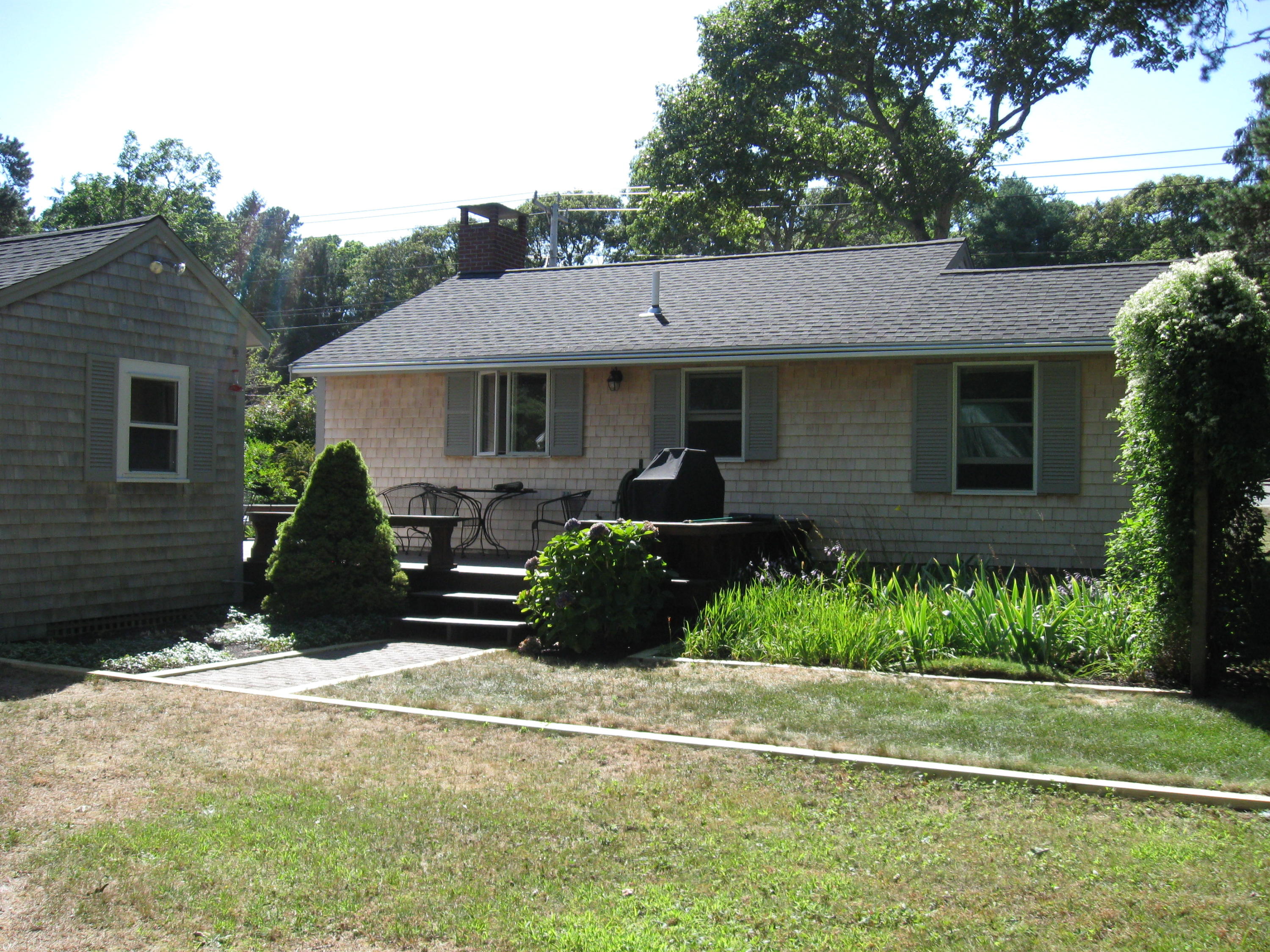 a front view of a house with a garden
