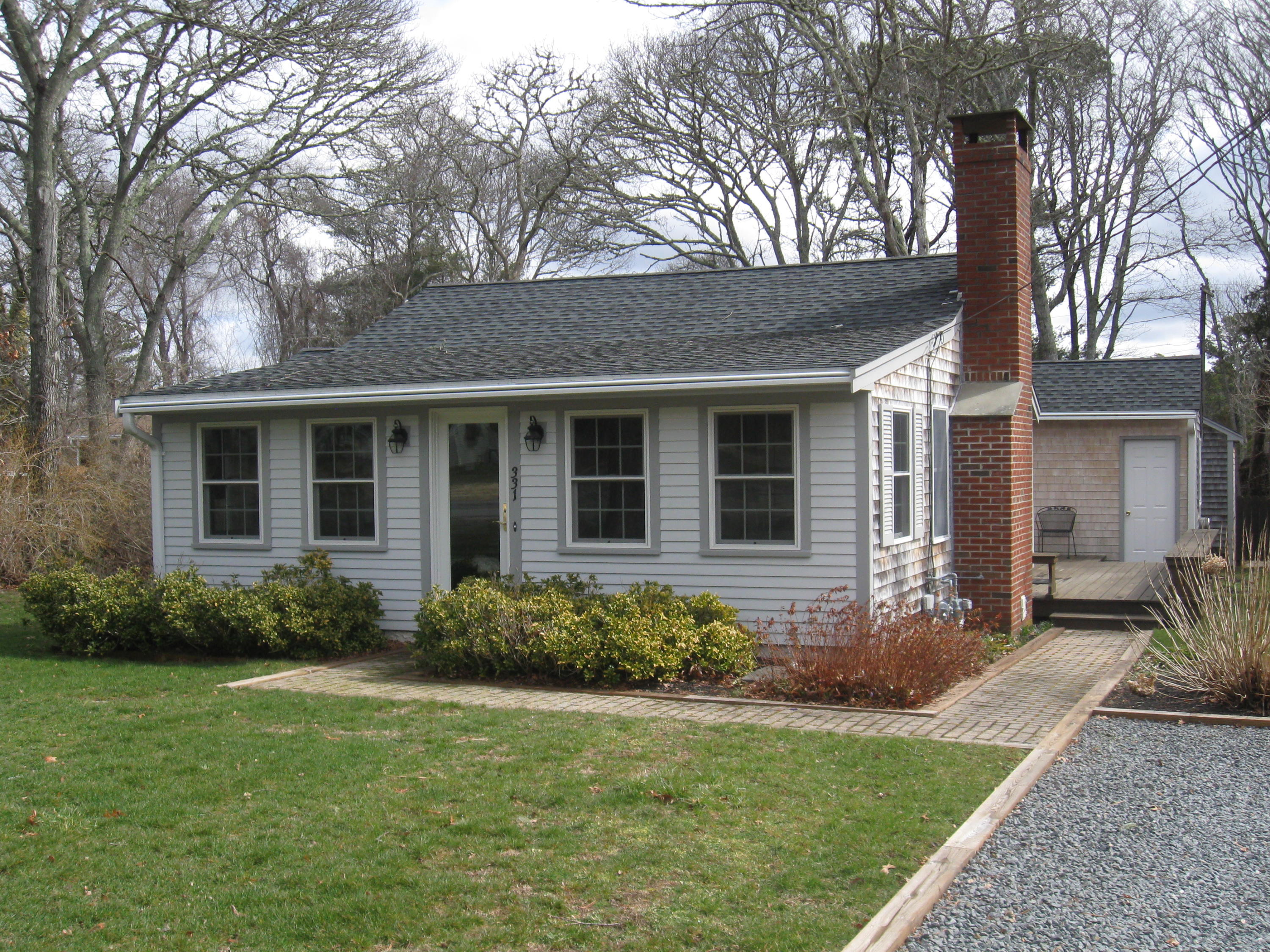 331 Shore Road Monument Beach, MA 02532 - Photo 3 of 11 a front view of a house with garden
