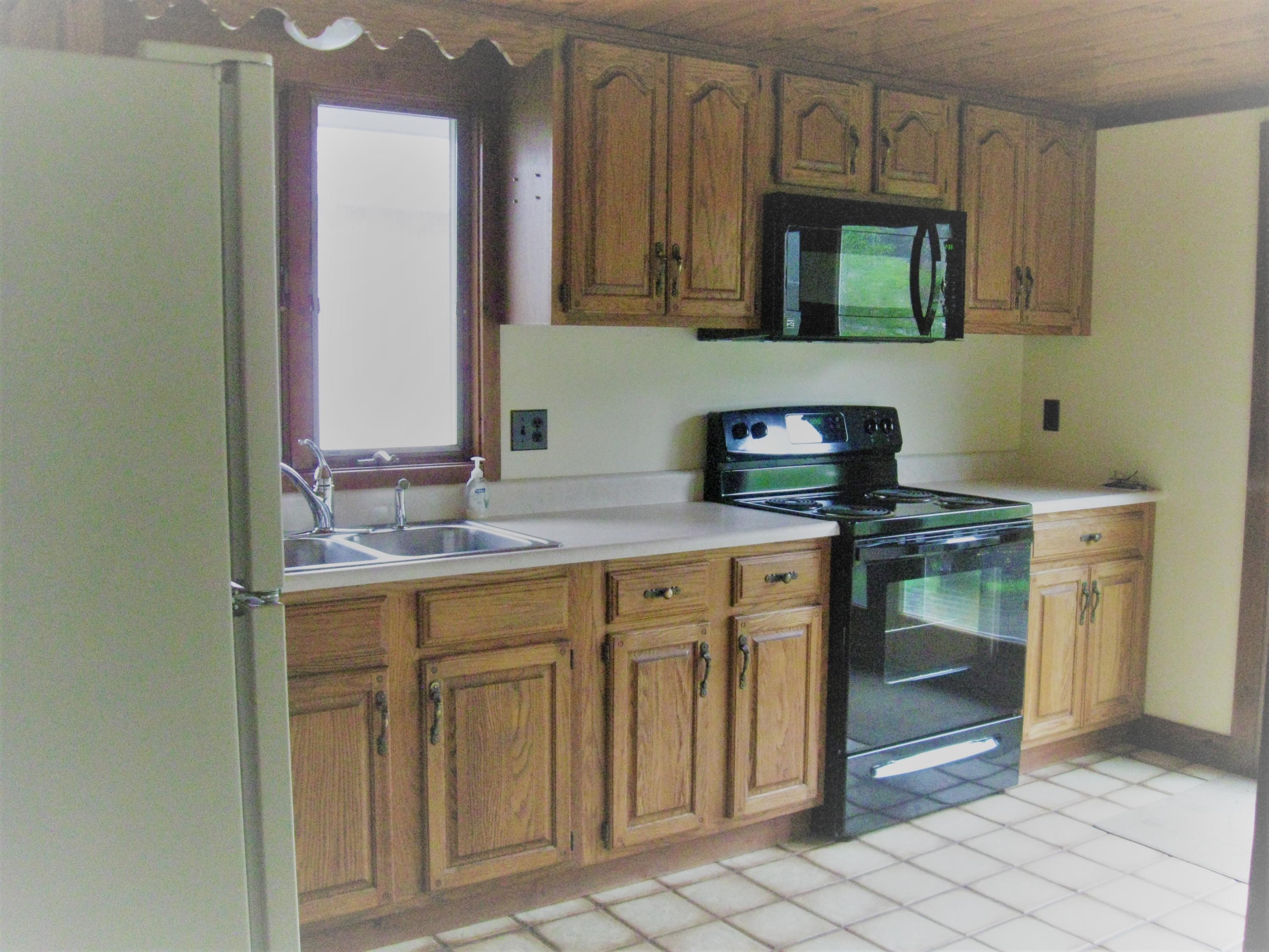 331 Shore Road Monument Beach, MA 02532 - Photo 8 of 11 a kitchen with granite countertop a sink and a stove