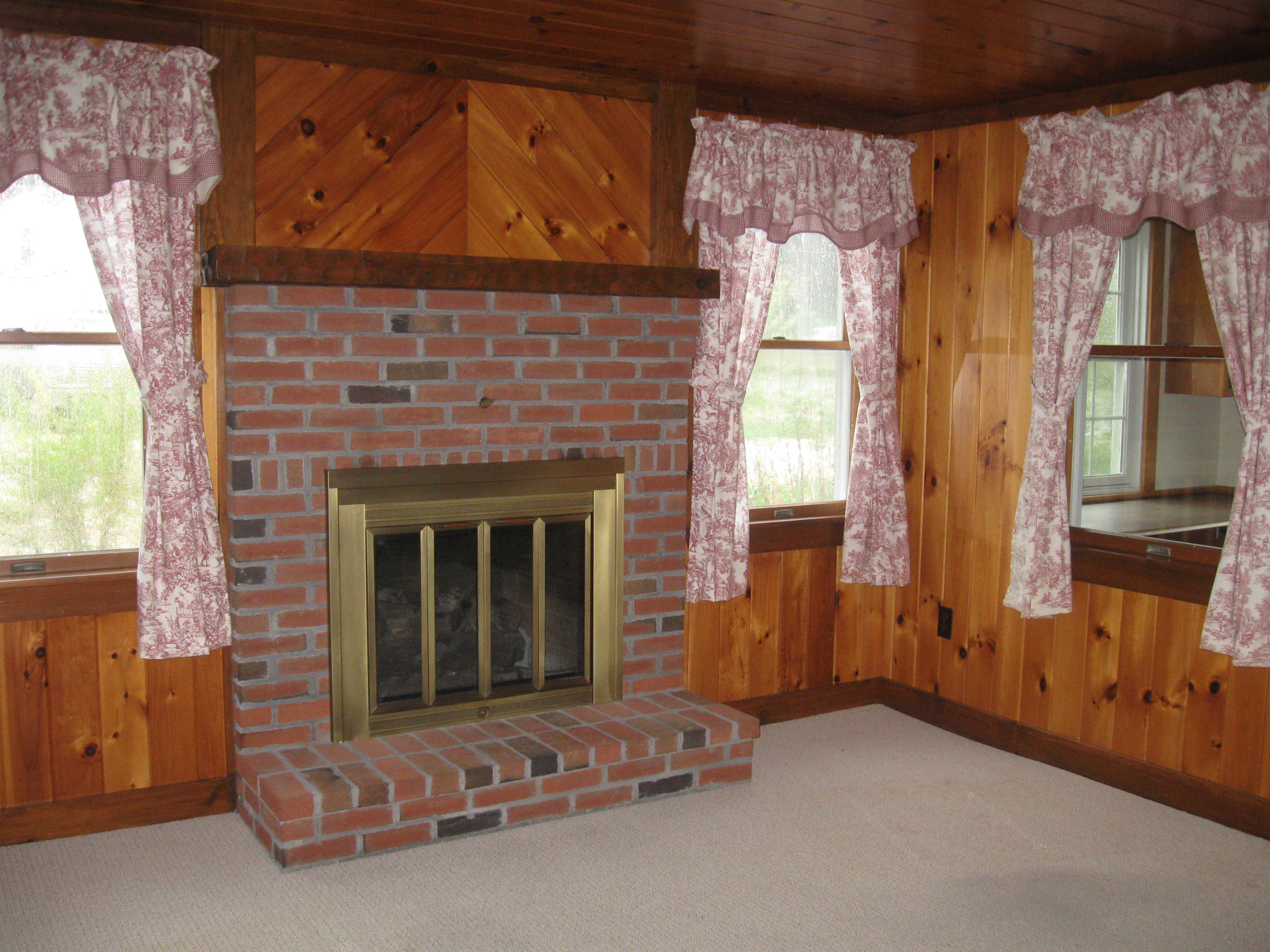 331 Shore Road Monument Beach, MA 02532 - Photo 9 of 11 a living room with furniture and a fireplace