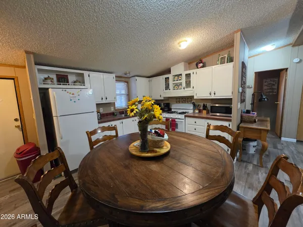 a kitchen with stainless steel appliances granite countertop a sink refrigerator and cabinets