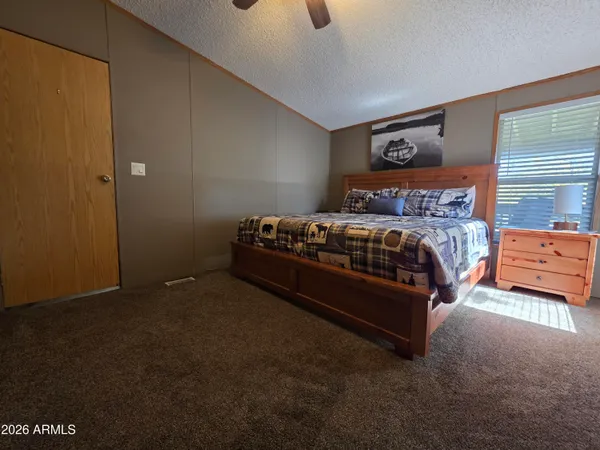 a bedroom with a bed and a chandelier