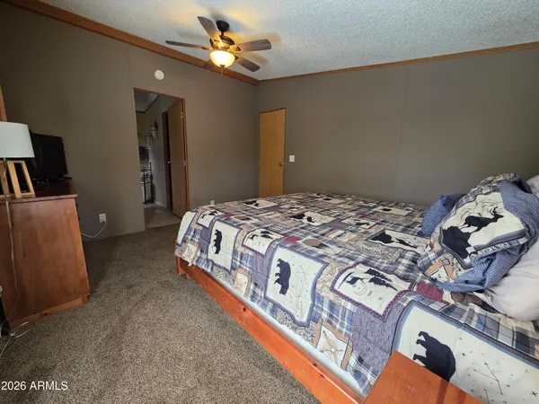 a bedroom with a bed and a chandelier