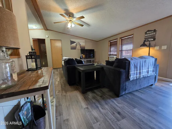 a living room with furniture and a wooden floor